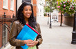 © michael spring - young student holding folders.