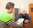 © DariaTrofimova - adult   men talking  with documents