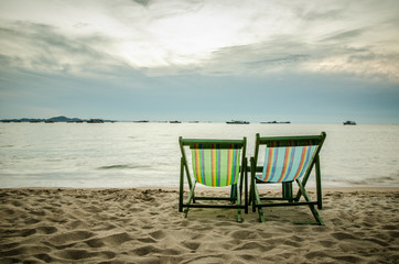 beach, two deck chairs and blue sky