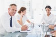 © WavebreakMediaMicro - Businessman smiling in a meeting
