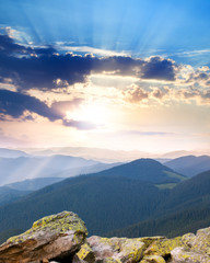 Wall Mural - majestic sunrise over the mountains with sunbeams - vertical