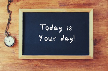 Wall Mural - top view of blackboard with the phrase today is your day written