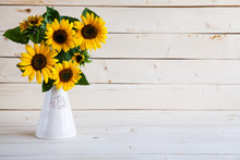 Sunflowers In A Vase On A Rustic, Gray Background