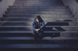© Wordley Calvo Stock - Young man lost in depression sitting on street stairs