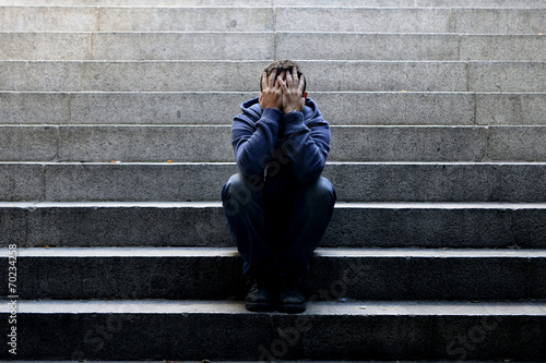 Cuadros en Lienzo Young homeless man sad crying in depression on ground street