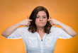 Woman plugging ears annoyed by loud noise ignoring someone