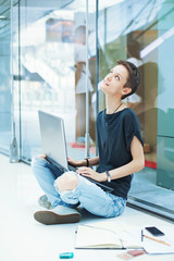 Young modern female worker looking up, thinking, inventing new ideas