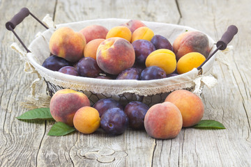 Poster - fresh fruits in a basket on wooden background