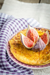 Wall Mural - Pile of pumpkin crepes decorated with fresh fig