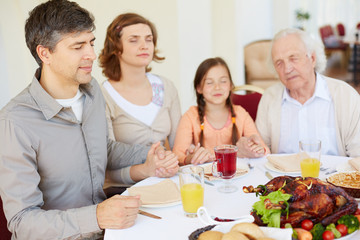 Poster - Praying before festive dinner