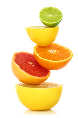 Fresh citrus fruit in a row on white background