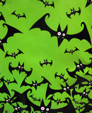 Fototapeta Tulipany - A flock of Halloween bats on a green background.