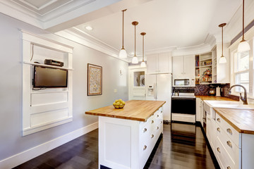 Wall Mural - White kitchen with wooden counter top island and TV