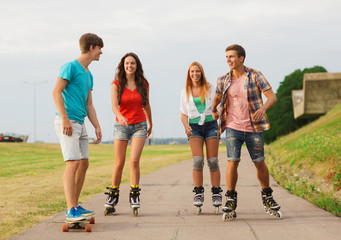 Canvas Print - group of smiling teenagers with roller-skates