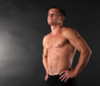 © Africa Studio - Handsome muscle young man on dark background