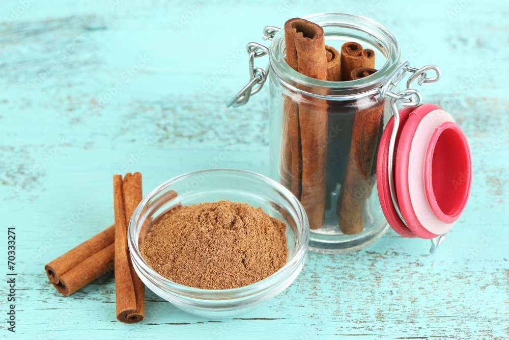 Cinnamon bark and cinnamon powder on wooden table
