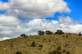 Fototapeta Sawanna - low altitude mountain arid zone and blue sky with clouds