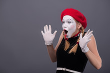 Waist-up Portrait Of Young Mime Girl Showing Something