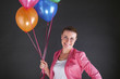 © Wisiel - woman with balloons over dark background smiling