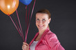 © Wisiel - woman with balloons over dark background smiling