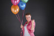 © Wisiel - woman with balloons over dark background smiling