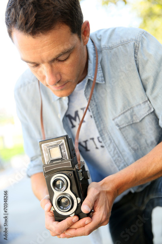 Plakat na papierze fotorealistycznym Fotograf za pomocą zabytkowej kamery