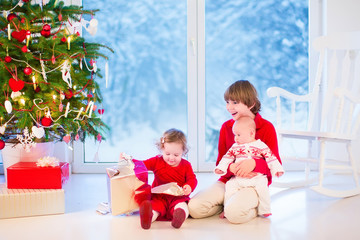 Wall Mural - Beautiful kids opening Christmas presents