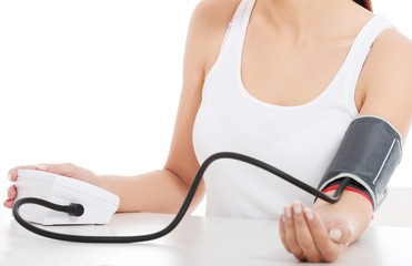 Woman measures her blood pressure