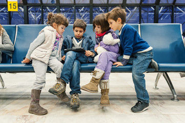  Kids waiting for flight inside Lisbon airport. Portela Airport i