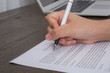 Close up of hand completing an employment application form