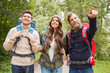 © Syda Productions - group of smiling friends with backpacks hiking