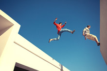 Two Brave Men Jumping Over The Roof, And Little Motion Blur