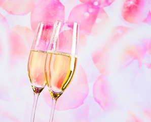 Wall Mural - champagne flutes on blur petals of roses background