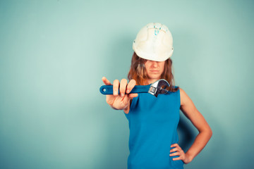 Wall Mural - Female builder holding a wrench