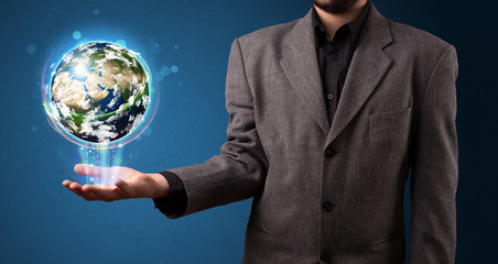 Wall Mural - Businessman holding glowing earth globe