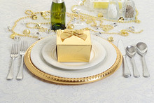 Silver And Gold Table Setting With Present