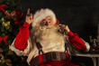 © Milles Studio - Portrait of emotional Santa Claus calling phone at home