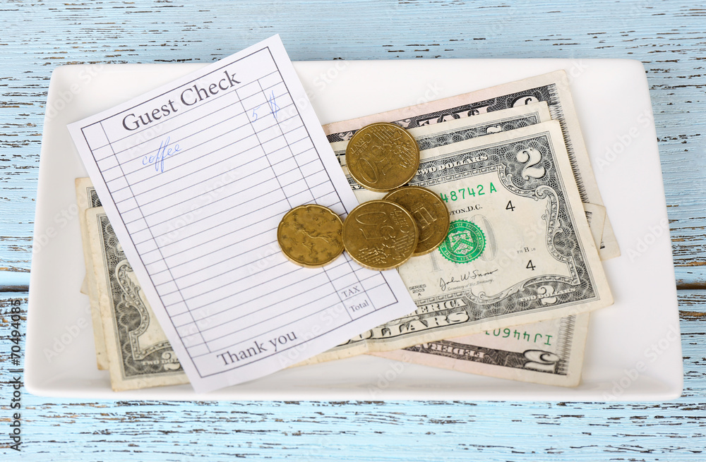 Check and money on table close-up