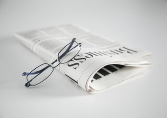 newspaper and glasses