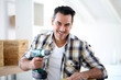 © goodluz - Man at home using electric drill