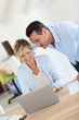 © goodluz - Business people working in office on laptop