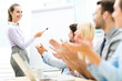 © pikselstock - Business people at a presentation, clapping