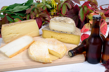 french cheese platter with bottles of beer