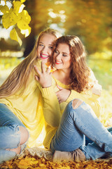 Two young girl in autumn forest