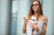 © A.Kazak - Successful businesswoman with cellphone while walking outdoor. C