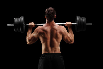 Sticker - Studio shot of a bodybuilder lifting a barbell