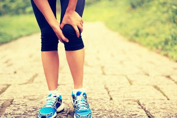 Sticker -  woman runner hold her sports injured knee