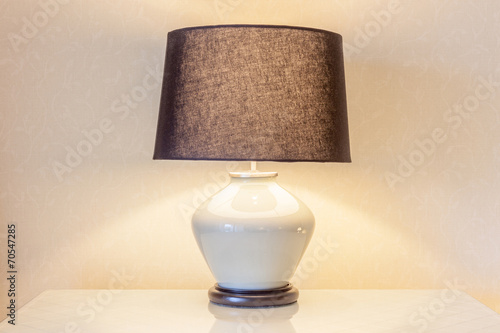 Fotografie, Obraz Table lamp and its shadow on wallpaper in the bedroom