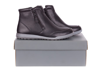 A pair of leather female low boots  on top of box