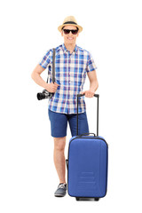 Canvas Print - Young male tourist posing with his baggage